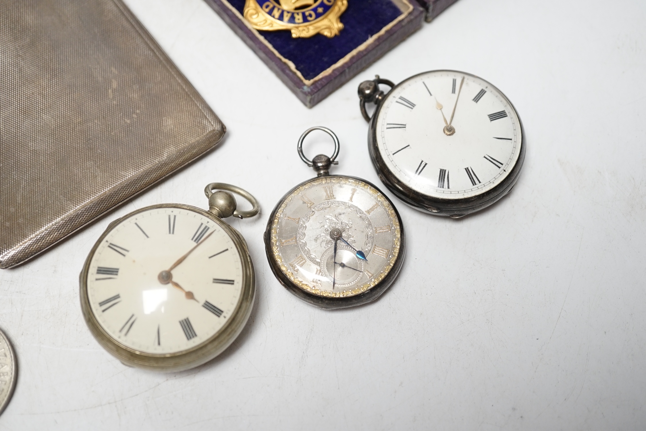 A George V engine turned silver cigarette case, 14.2cm, three pocket watches including two silver and a small group of coins and medals. Condition - poor to fair